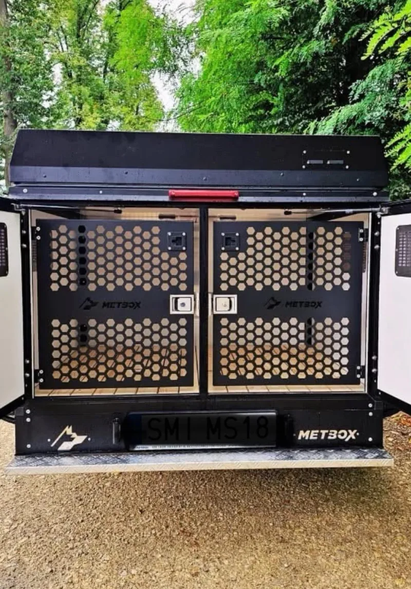 METBOX black dual dog crate with honeycomb mesh doors and wooden slat floor, rear view