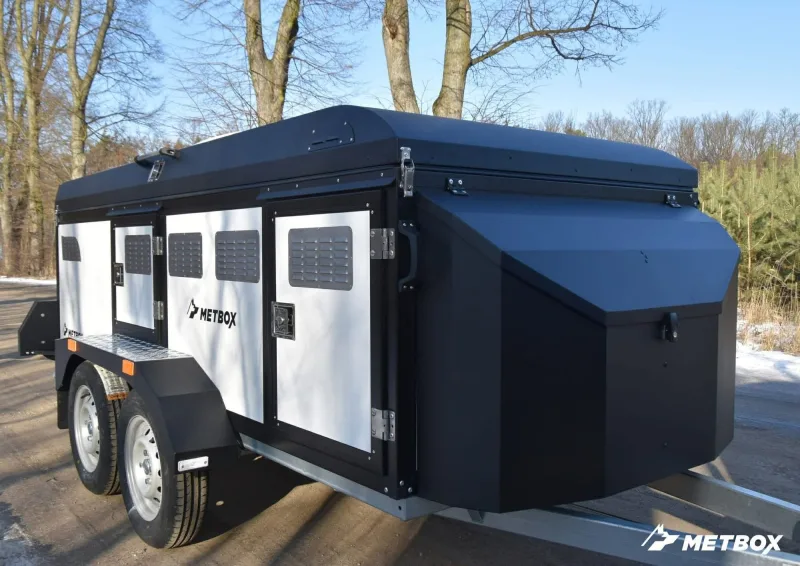 METBOX dual-axle white and black dog transport trailer with vented compartment doors