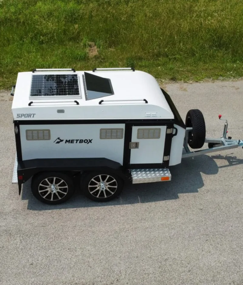 METBOX Sport white dog trailer with solar panel, roof rails, and vented side panels
