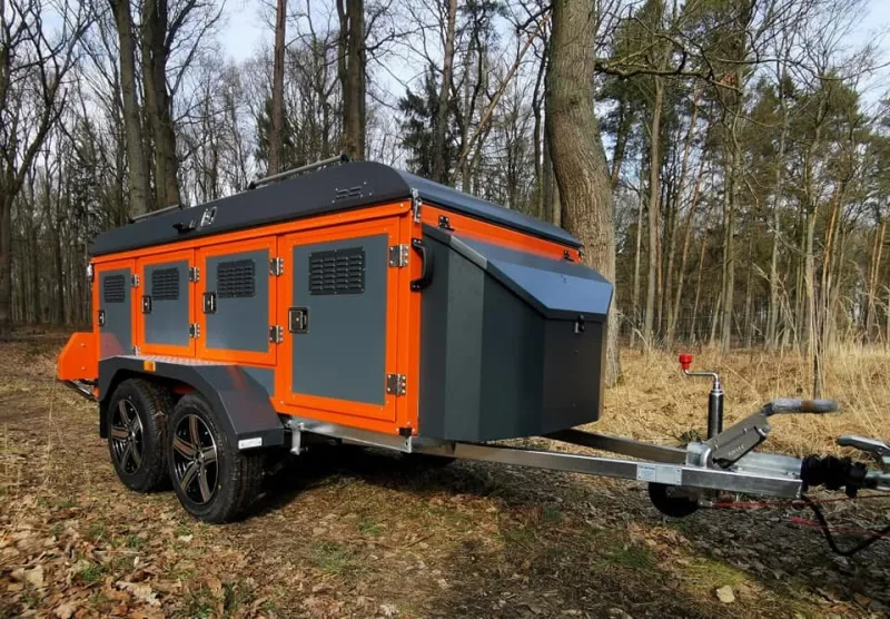 Orange and charcoal four-door ventilated professional dog transport trailer